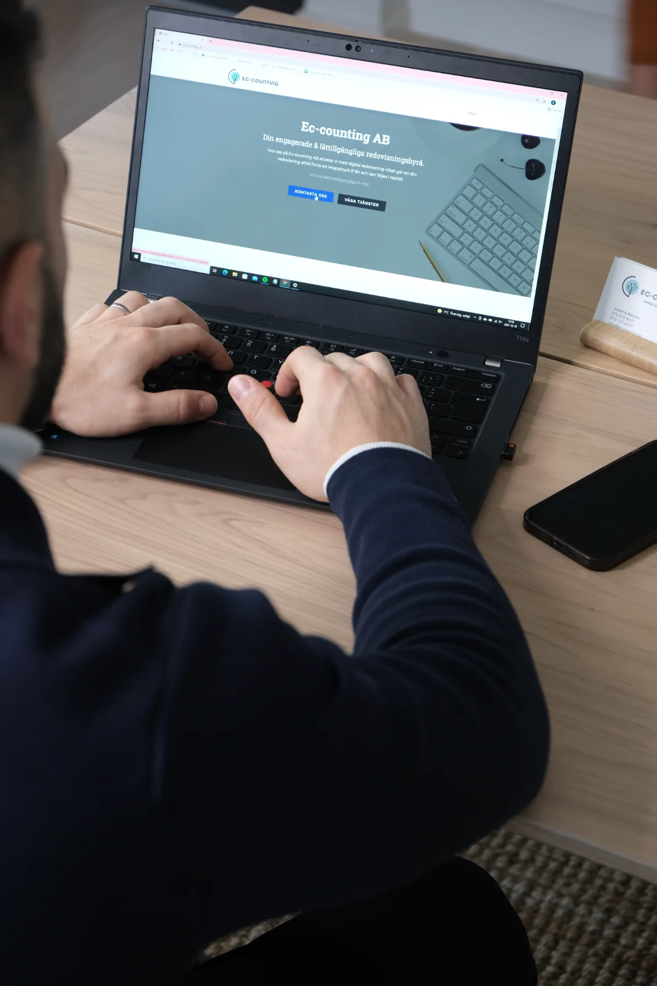 Skrivbord med bokföringsmaterial, miniräknare, rapporter och laptop